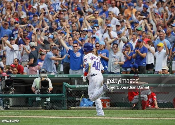 Fans cheer as Willson Contreras of the Chicago Cubs runs the bases after hitting a two run home run in the 6th inning against the Washington...