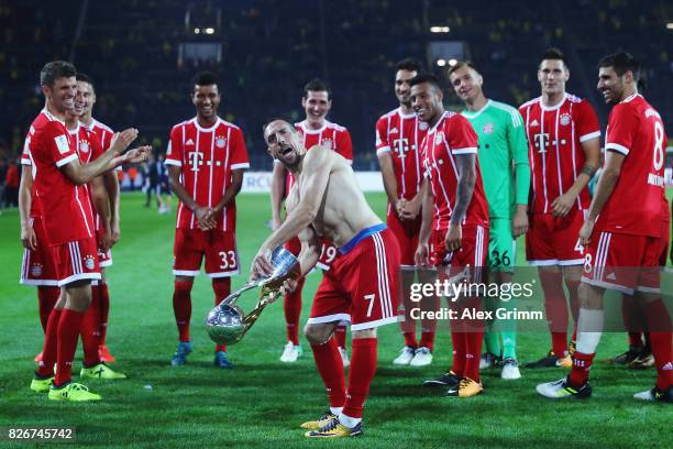 Franck Ribery and team mates of Muenchen celebrate with the trophy after his team won the DFL Supercup 2017 match between Borussia Dortmund and...