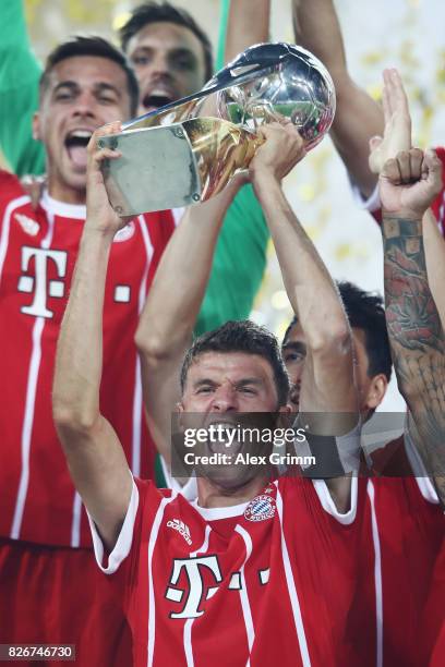 Team captain Thomas Mueller celebrates with the trophy after his team won the DFL Supercup 2017 match between Borussia Dortmund and Bayern Muenchen...