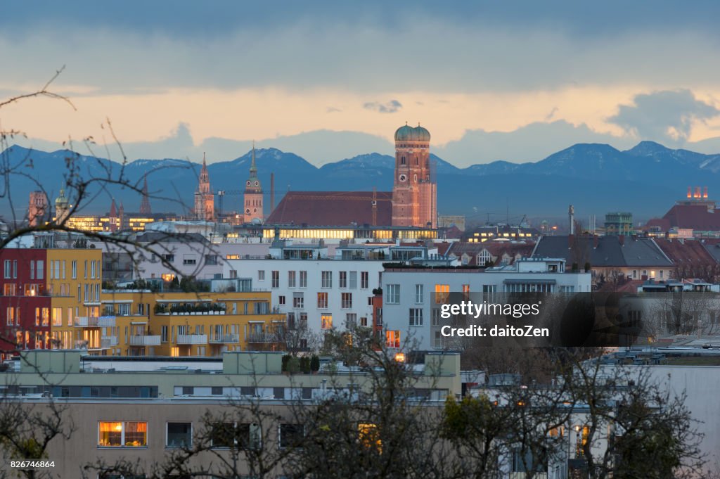 Munich skyline with Frauenkirche Cathedral and Alps mountain range in the background, Munich, Bavaria, Germany.