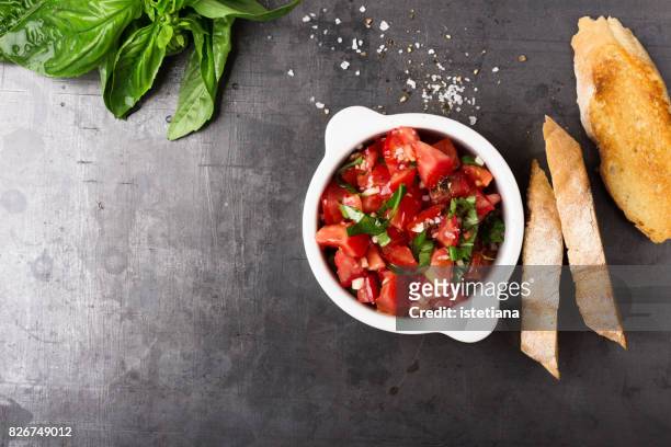 messthetics. tomato bruschetta preparation - antipasto fotografías e imágenes de stock