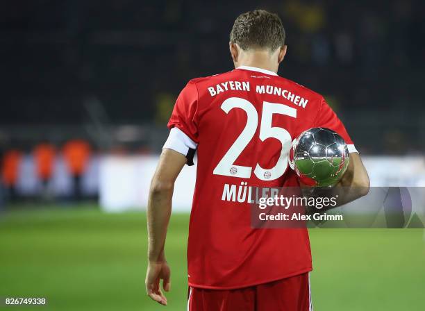 Team captain Thomas Mueller celebrates with the trophy after his team won the DFL Supercup 2017 match between Borussia Dortmund and Bayern Muenchen...