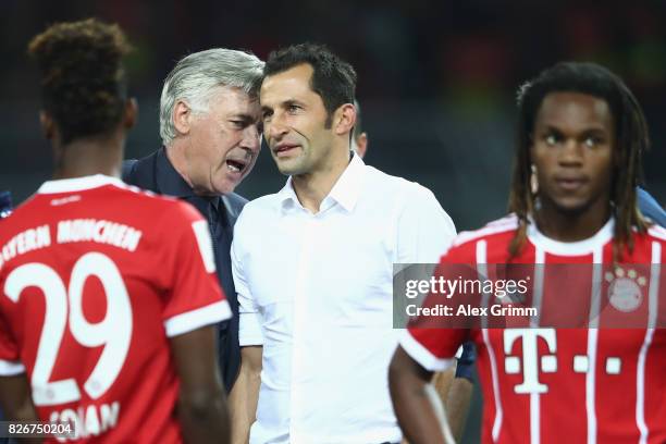 Head coach Carlo Ancelotti and sports director Hasan Salihamidzic chat after their team won the DFL Supercup 2017 match between Borussia Dortmund and...