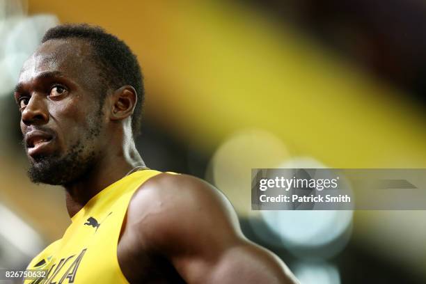 Usain Bolt of Jamaica looks on during a lap of honour following finishing in third place in the mens 100m final during day two of the 16th IAAF World...