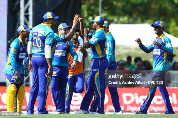 In this handout image provided by CPL T20, The Barbados Tridents celebrate the dismissal of Kumar Sangakarra of the Jamaica Tallawahs during Match 3...