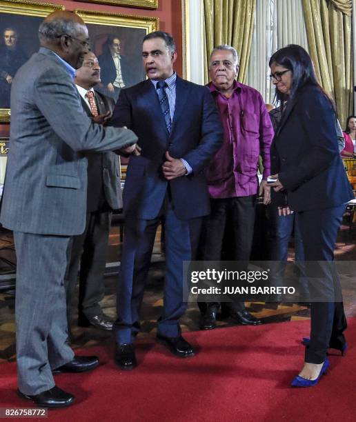 Venezuelan new Attorney General Tarek William Saab shakes hands with first Vice-President Aristobulo Isturiz next to the president of Venezuela's...