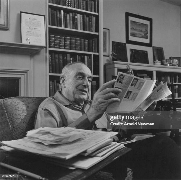 American city planner Robert Moses reads as he sits in his office, New York, New York, April 8, 1964.