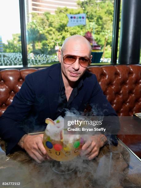 Grammy award winning artist Pitbull samples his creation the 'Hot & Wild Spicy 305 Pineapple ' goblet made with Voli 305 during its debut at Sugar...