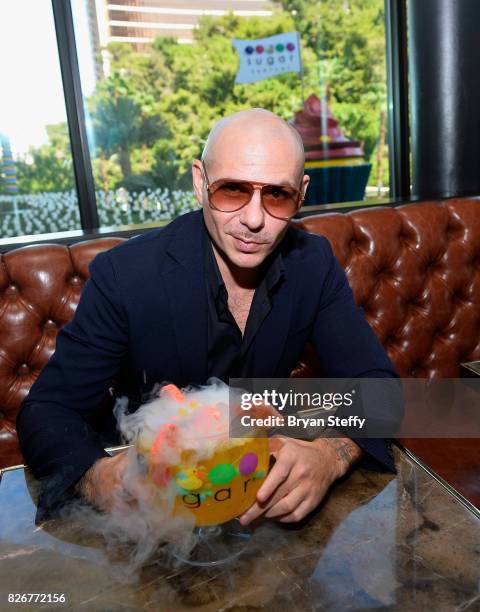 Grammy award winning artist Pitbull samples his creation the 'Fuzzy Peach Penguin Mango ' goblet made with Voli 305 during its debut at Sugar Factory...