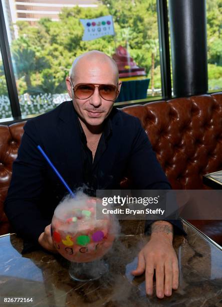 Grammy award winning artist Pitbull samples his creation the 'Watermelon Patch ' goblet made with Voli 305 during its debut at Sugar Factory American...