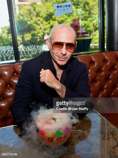 Grammy award winning artist Pitbull samples his creation the 'Watermelon Patch ' goblet made with Voli 305 during its debut at Sugar Factory American...