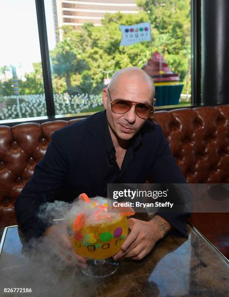 Grammy award winning artist Pitbull samples his creation the 'Fuzzy Peach Penguin Mango ' goblet made with Voli 305 during its debut at Sugar Factory...