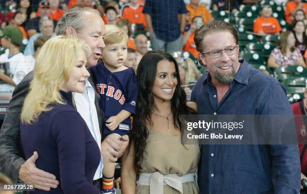 Houston Astros owner Jim Crane, left,with his wife Whitney pose with Jeff Bagwell and his wife Rachel after ceremony celebrating his induction into...