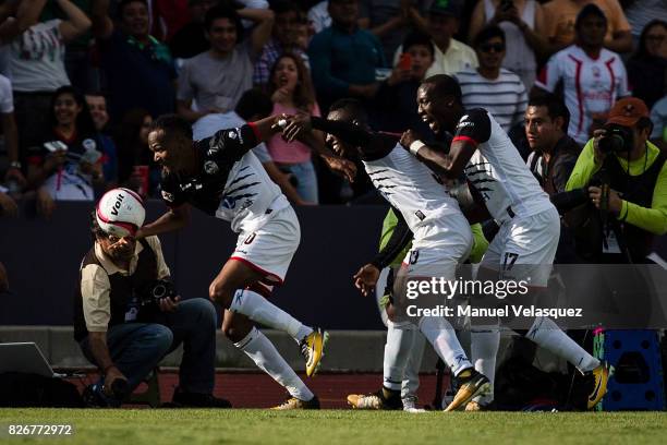 Luis Quinones of Lobos BUAP celebrates with teammates after scoring the third goal if his team during the third round match between Lobos BUAP and...