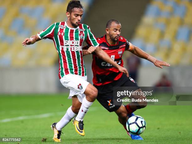 Gustavo Scarpa of Fluminense struggles for the ball with Diego Rosa of Atletico GO during a match between Fluminense and Atletico GO as part of...