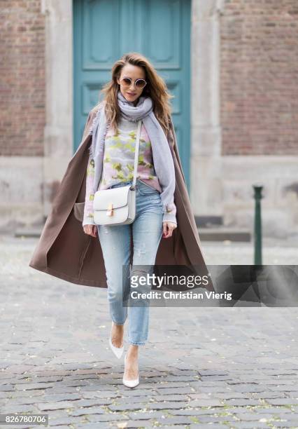 Model and fashion blogger Alexandra Lapp wearing colorful cashmere pullover by Heartbreaker, high waist five-pocket 501 skinny jeans from Levis,...