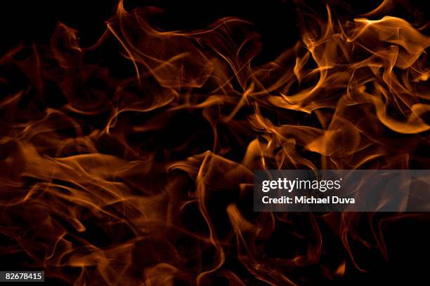 flames close up on a black background - flame stock pictures, royalty-free photos & images