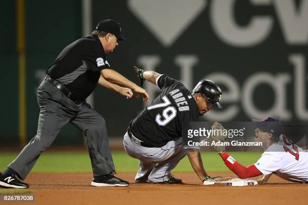 Jose Abreu of the Chicago White Sox is safe at second base after dodging the tag of Brock Holt of the Boston Red Sox in the eighth inning of a game...