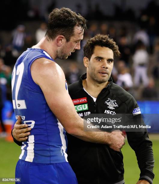 Daniel Wells of the Magpies hugs former Kangaroos teammate Todd Goldstein during the 2017 AFL round 20 match between the North Melbourne Kangaroos...