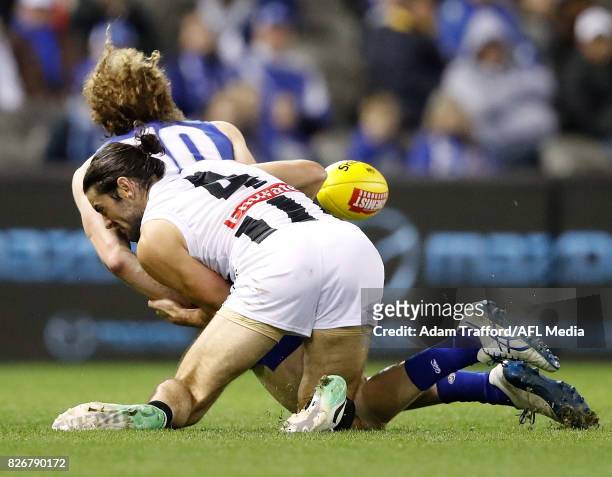 Ben Brown of the Kangaroos is tackled by Brodie Grundy of the Magpies during the 2017 AFL round 20 match between the North Melbourne Kangaroos and...