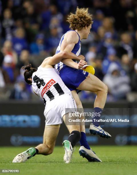 Ben Brown of the Kangaroos is tackled by Brodie Grundy of the Magpies during the 2017 AFL round 20 match between the North Melbourne Kangaroos and...