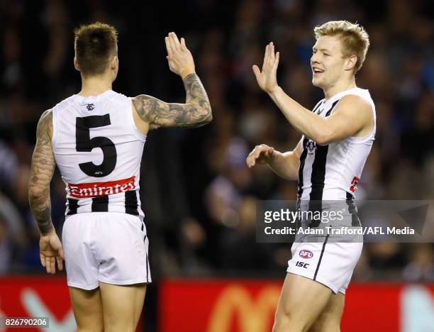 Jordan De Goey of the Magpies celebrates a goal with Jamie Elliott of the Magpies during the 2017 AFL round 20 match between the North Melbourne...