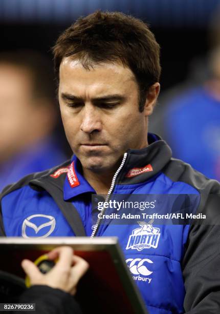 Brad Scott, Senior Coach of the Kangaroos makes changes during the 2017 AFL round 20 match between the North Melbourne Kangaroos and the Collingwood...