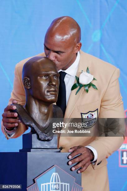 Jason Taylor kisses his bust during the Pro Football Hall of Fame Enshrinement Ceremony at Tom Benson Hall of Fame Stadium on August 5, 2017 in...
