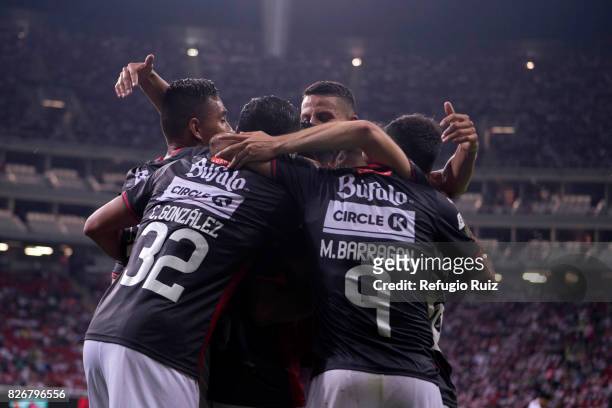 Luis Perez of Necaxa celebrates with temmates after scoring the second goal of his team during the third round match between Chivas and Necaxa as...