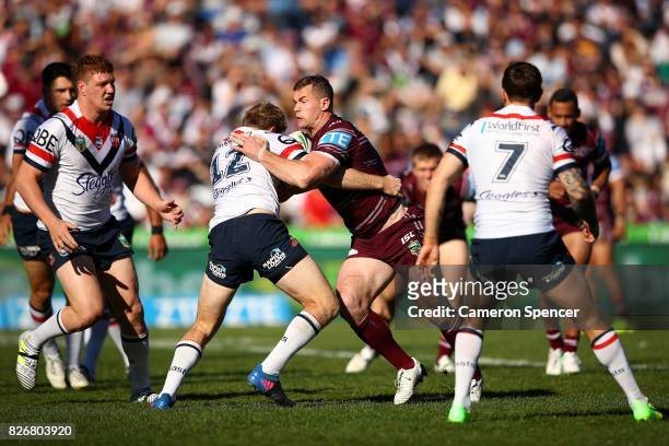 Brenton Lawrence of the Sea Eagles is tackled during the round 22 NRL match between the Manly Warringah Sea Eagles and the Sydney Roosters at...