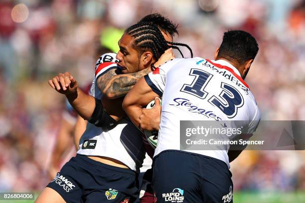 Martin Taupau of the Sea Eagles is tackled during the round 22 NRL match between the Manly Warringah Sea Eagles and the Sydney Roosters at Lottoland...