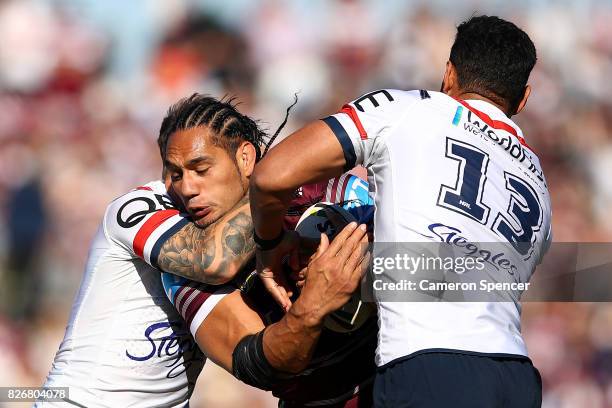 Martin Taupau of the Sea Eagles is tackled during the round 22 NRL match between the Manly Warringah Sea Eagles and the Sydney Roosters at Lottoland...