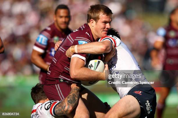 Jake Trbojevic of the Sea Eagles is tackled during the round 22 NRL match between the Manly Warringah Sea Eagles and the Sydney Roosters at Lottoland...