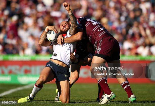 Blake Ferguson of the Roosters is tackled during the round 22 NRL match between the Manly Warringah Sea Eagles and the Sydney Roosters at Lottoland...