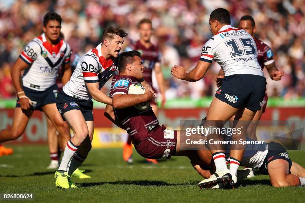 Lloyd Perrett of the Sea Eagles is tackled during the round 22 NRL match between the Manly Warringah Sea Eagles and the Sydney Roosters at Lottoland...