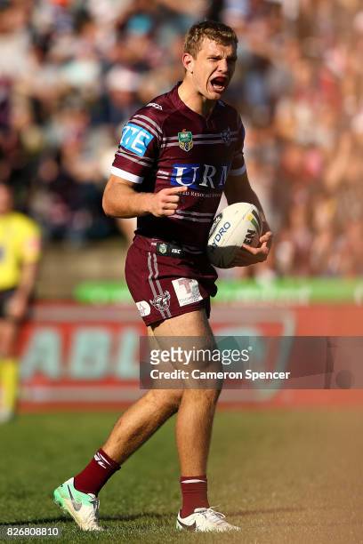 Tom Trbojevic of the Sea Eagles celebrates scoring a try during the round 22 NRL match between the Manly Warringah Sea Eagles and the Sydney Roosters...