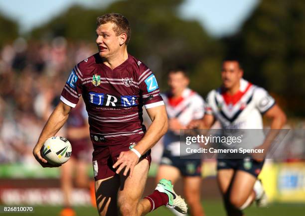 Tom Trbojevic of the Sea Eagles makes a break during the round 22 NRL match between the Manly Warringah Sea Eagles and the Sydney Roosters at...