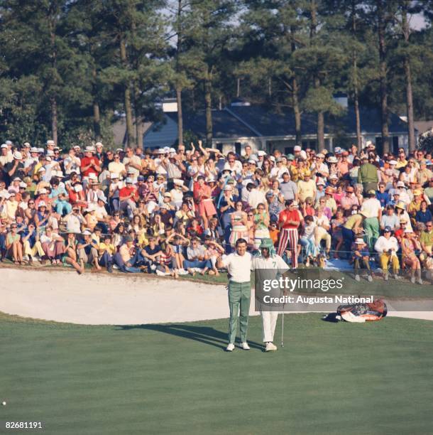 Charles Coody with his caddy Walter Pritchet after his final putt to win on the 18th Green during the 1971 Masters Tournament at Augusta National...