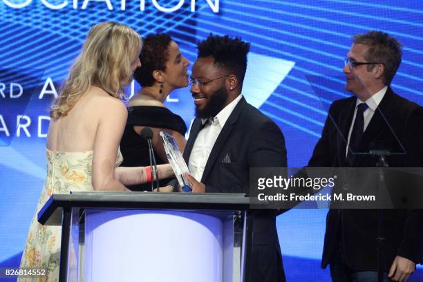 Collider's Allison Keene and TCA Treasurer/Salon's Melanie McFarland present the award for 'Outstanding Achievement in Comedy' for 'Atlanta' to...