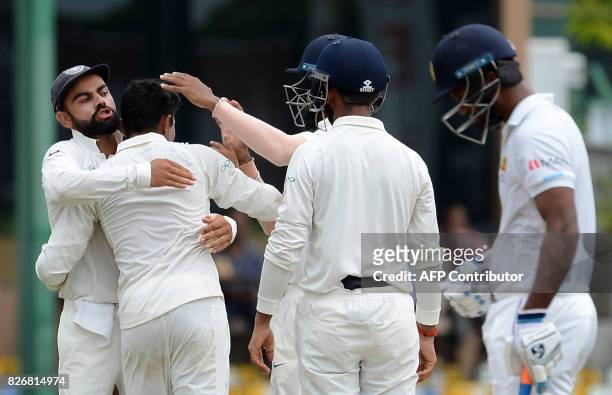 India's Ravindra Jadeja celebrates with teammates after dismissing Sri Lanka's Dinesh Chandimal during the fourth day of the second Test match...