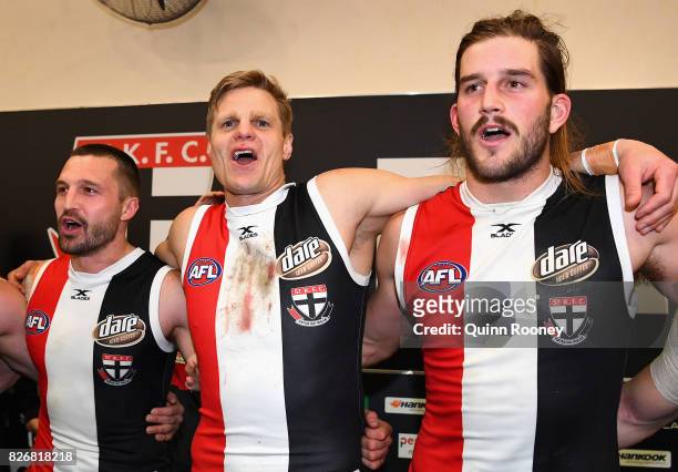 Jarryn Geary, Nick Riewoldt and Josh Bruce of the Saints sing the song in the rooms after winning the round 20 AFL match between the St Kilda Saints...