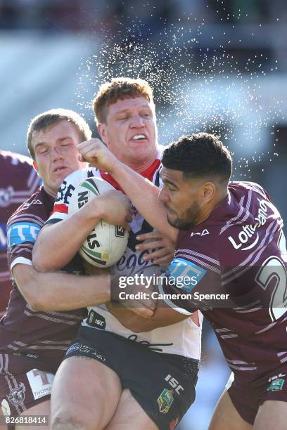Dylan Napa of the Roosters is tackled during the round 22 NRL match between the Manly Warringah Sea Eagles and the Sydney Roosters at Lottoland on...