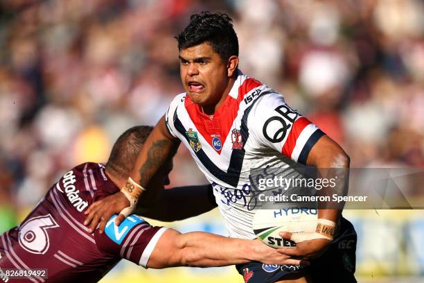 Latrell Mitchell of the Roosters is tackled during the round 22 NRL match between the Manly Warringah Sea Eagles and the Sydney Roosters at Lottoland...