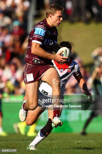 Tom Trbojevic of the Sea Eagles runs the ball during the round 22 NRL match between the Manly Warringah Sea Eagles and the Sydney Roosters at...