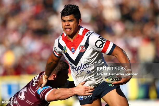 Latrell Mitchell of the Roosters is tackled during the round 22 NRL match between the Manly Warringah Sea Eagles and the Sydney Roosters at Lottoland...