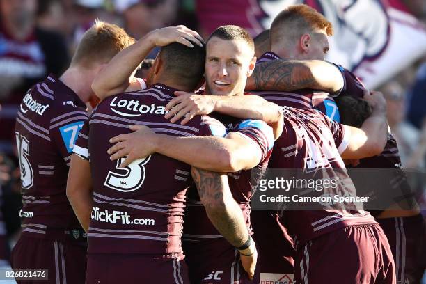 Blake Green of the Sea Eagles celebrates with team mates after a try by Daly Cherry-Evans of the Sea Eagles during the round 22 NRL match between the...