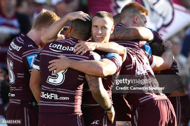 Blake Green of the Sea Eagles celebrates with team mates after a try by Daly Cherry-Evans of the Sea Eagles during the round 22 NRL match between the...