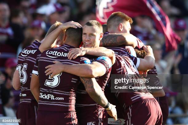 Blake Green of the Sea Eagles celebrates with team mates after a try by Daly Cherry-Evans of the Sea Eagles during the round 22 NRL match between the...