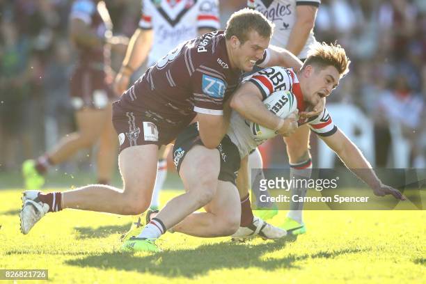 Connor Watson of the Roosters is tackled during the round 22 NRL match between the Manly Warringah Sea Eagles and the Sydney Roosters at Lottoland on...