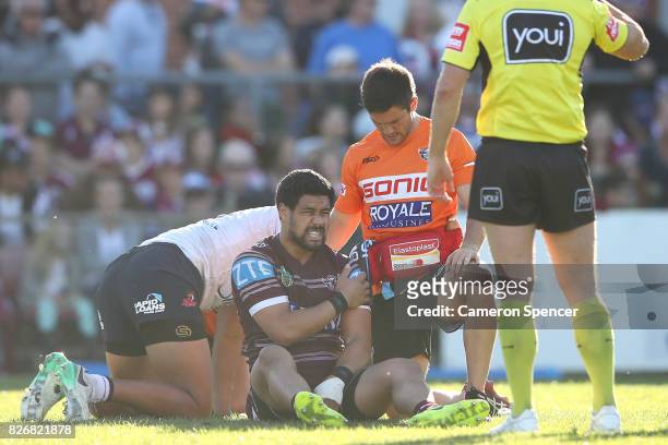 Matt Wright of the Sea Eagles receives attention during the round 22 NRL match between the Manly Warringah Sea Eagles and the Sydney Roosters at...